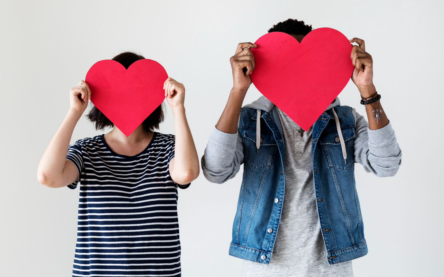 Happy Couple Holding Red Heart Icons